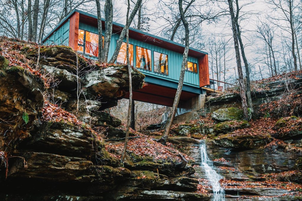 Container house over a waterfall