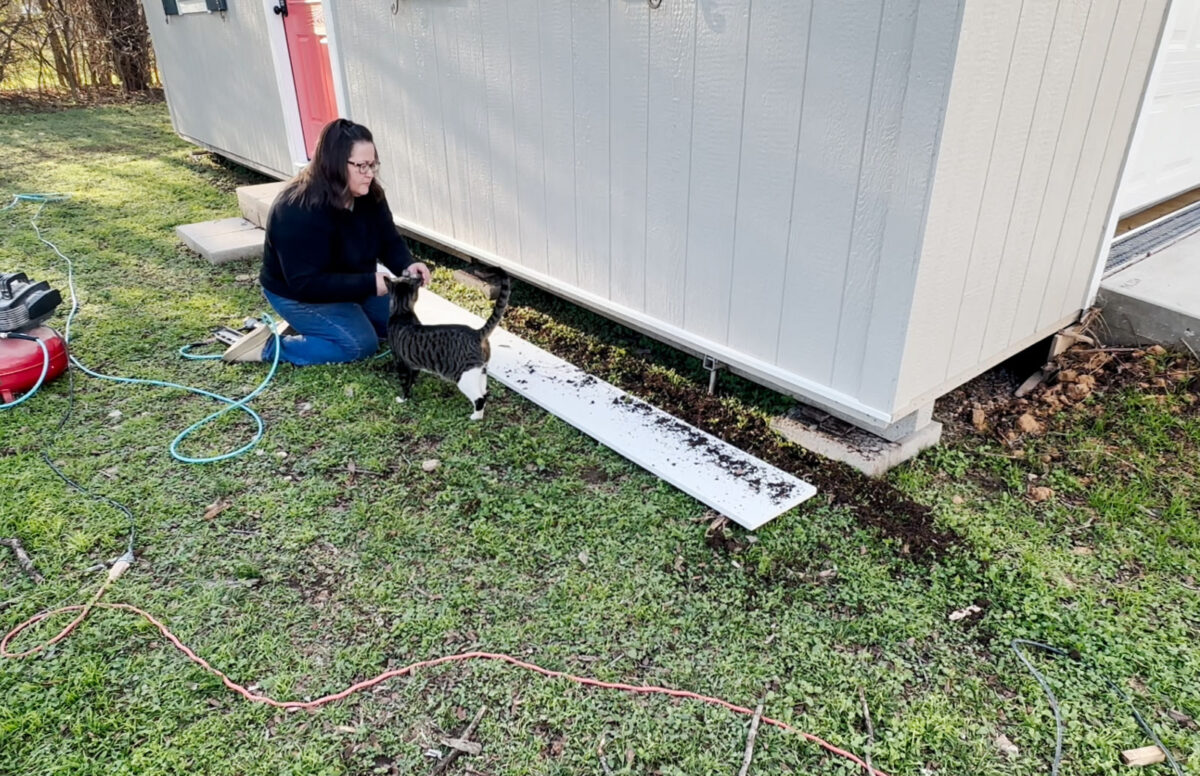 Digging a trench for shed skirting made from PVC boards