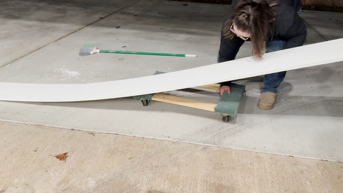 Use furniture dolly to move 27-foot PVC boards to use as skirting on backyard workshop