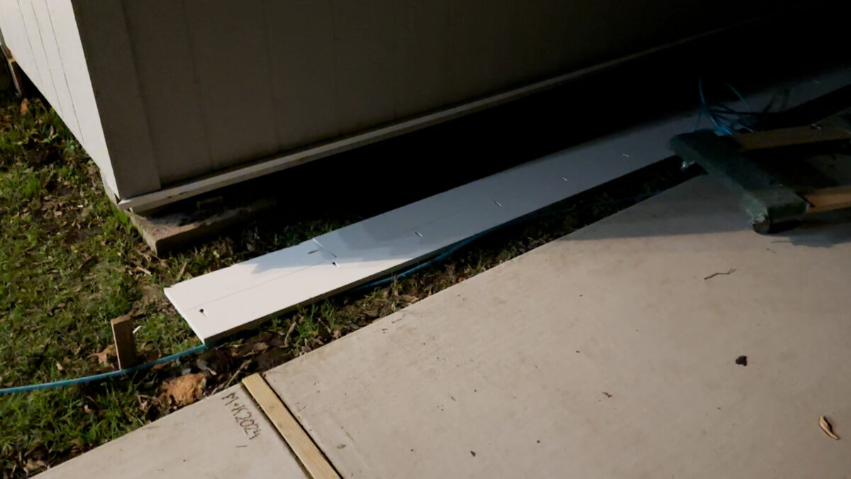 Long skirting piece made of PVC boards joined together for backyard workshop