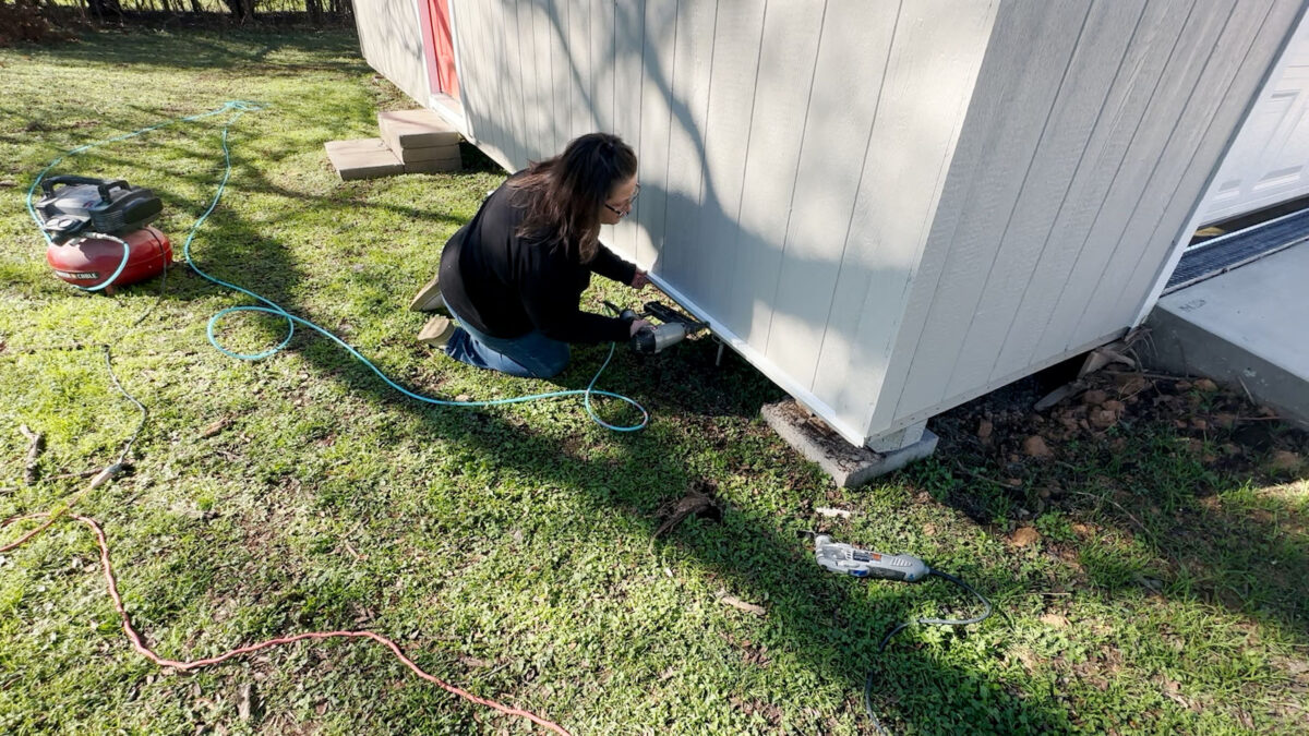 Add skirting to outdoor shed -- nail a ledger board as a transition between siding and skirting.