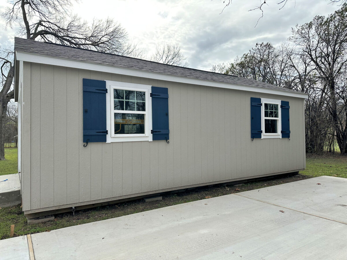 The back side of my back yard shed workshop with new DIY board and batten shutters installed