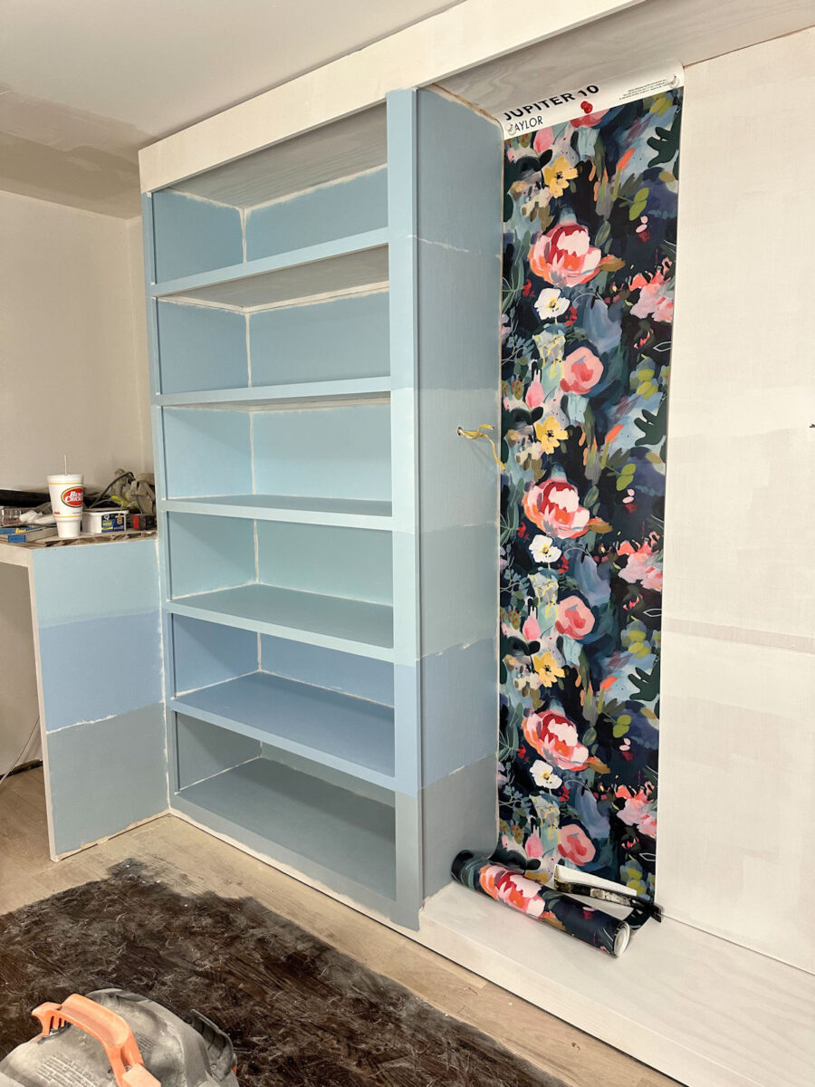 Six light blue paint samples for walk-in closet cabinets with floral wallpaper